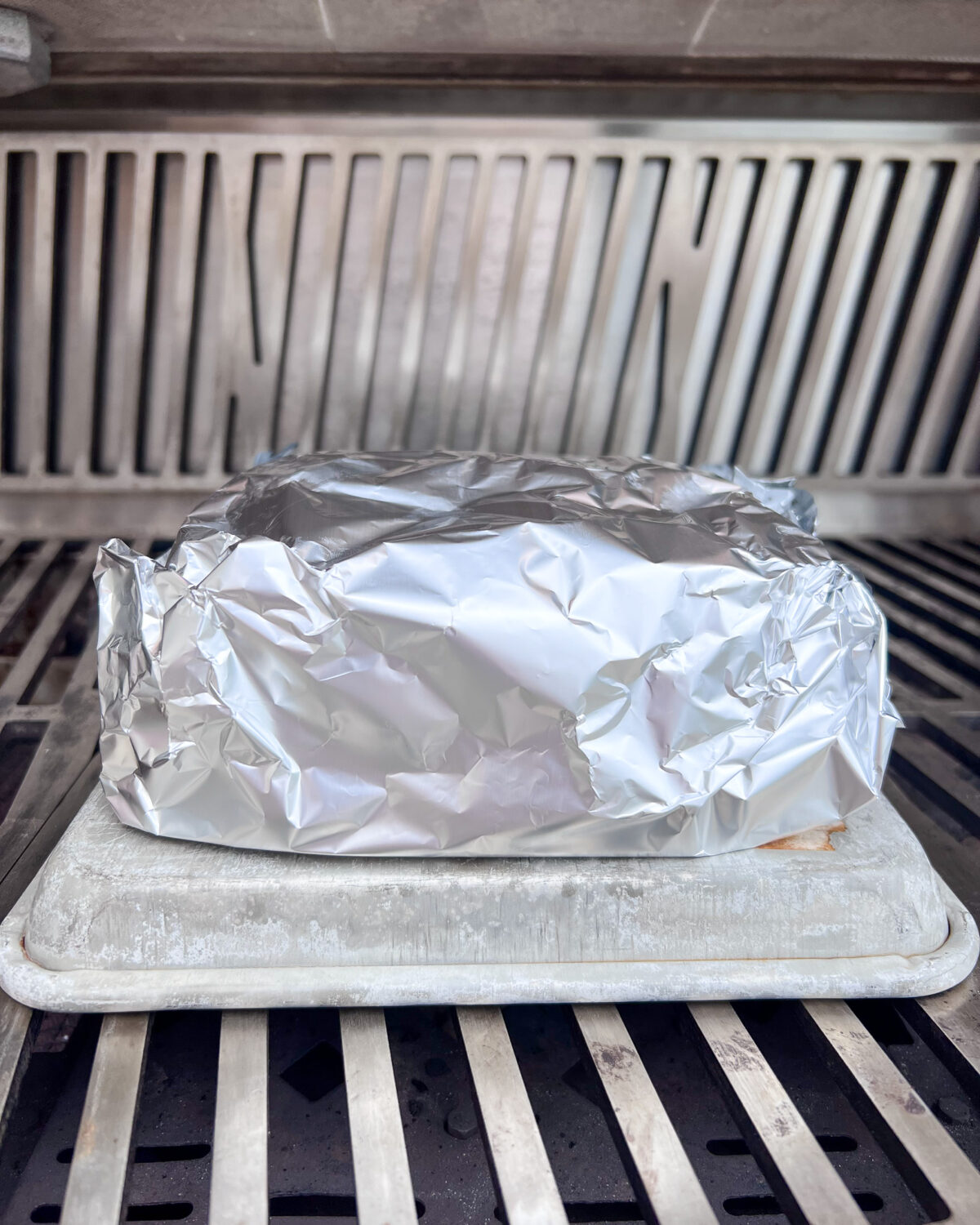 Wrap the sliders in aluminum foil and place on a sheet pan.