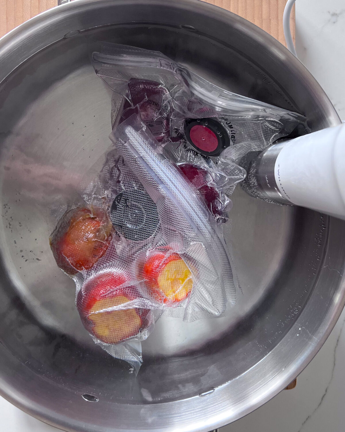 Beets are placed in a preheated water bath to make a sous-vide beet salad.