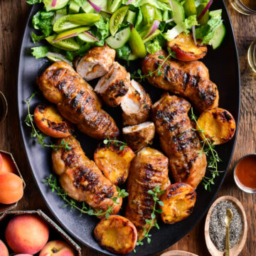 A larger platter of (Stuffed) Chicken Breasts with Peach BBQ Sauce and a green salad.