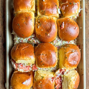 A tray of chopped Italian Sliders cut into pieces.