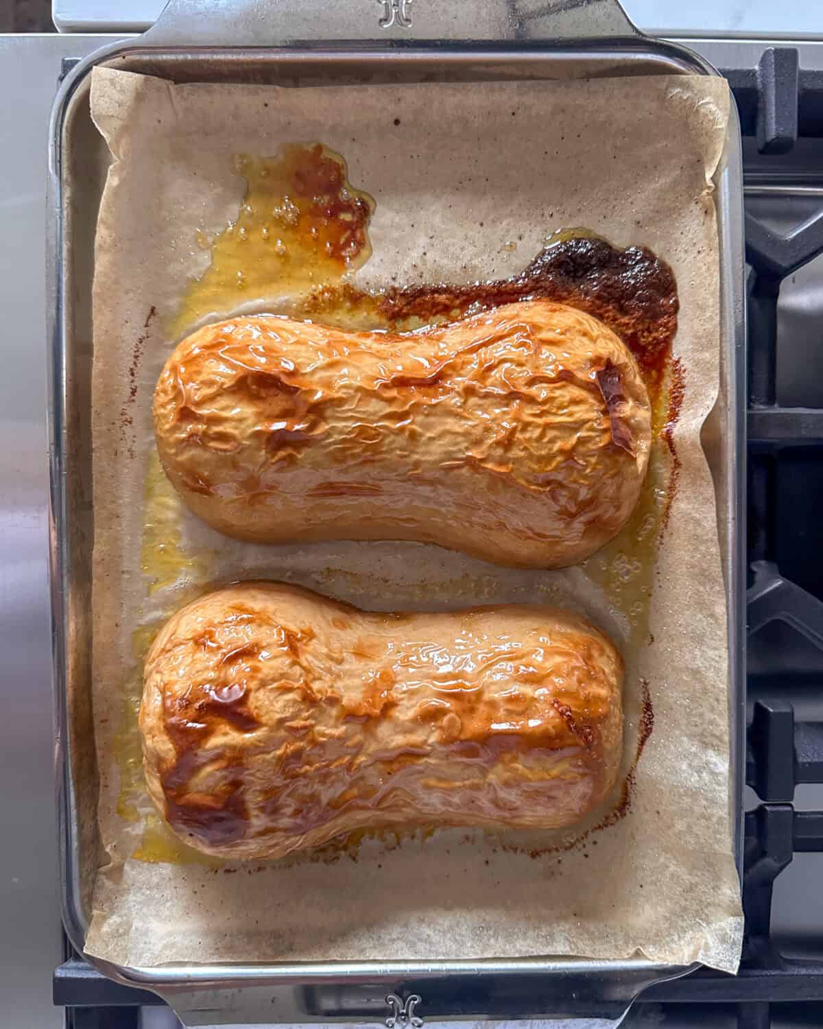 Two roasted butternut squash on a tray.