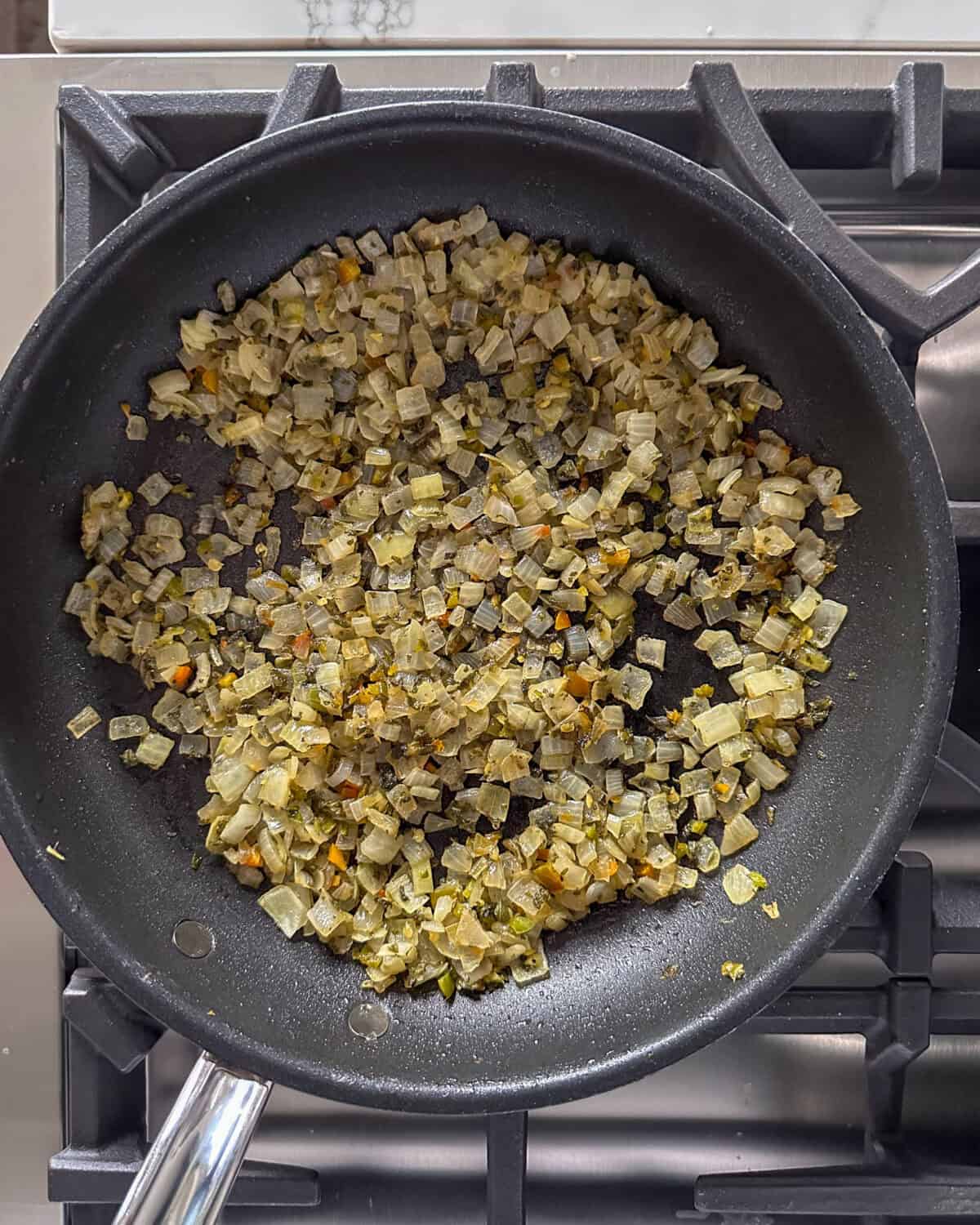 A pan with sautéed onions and sage.