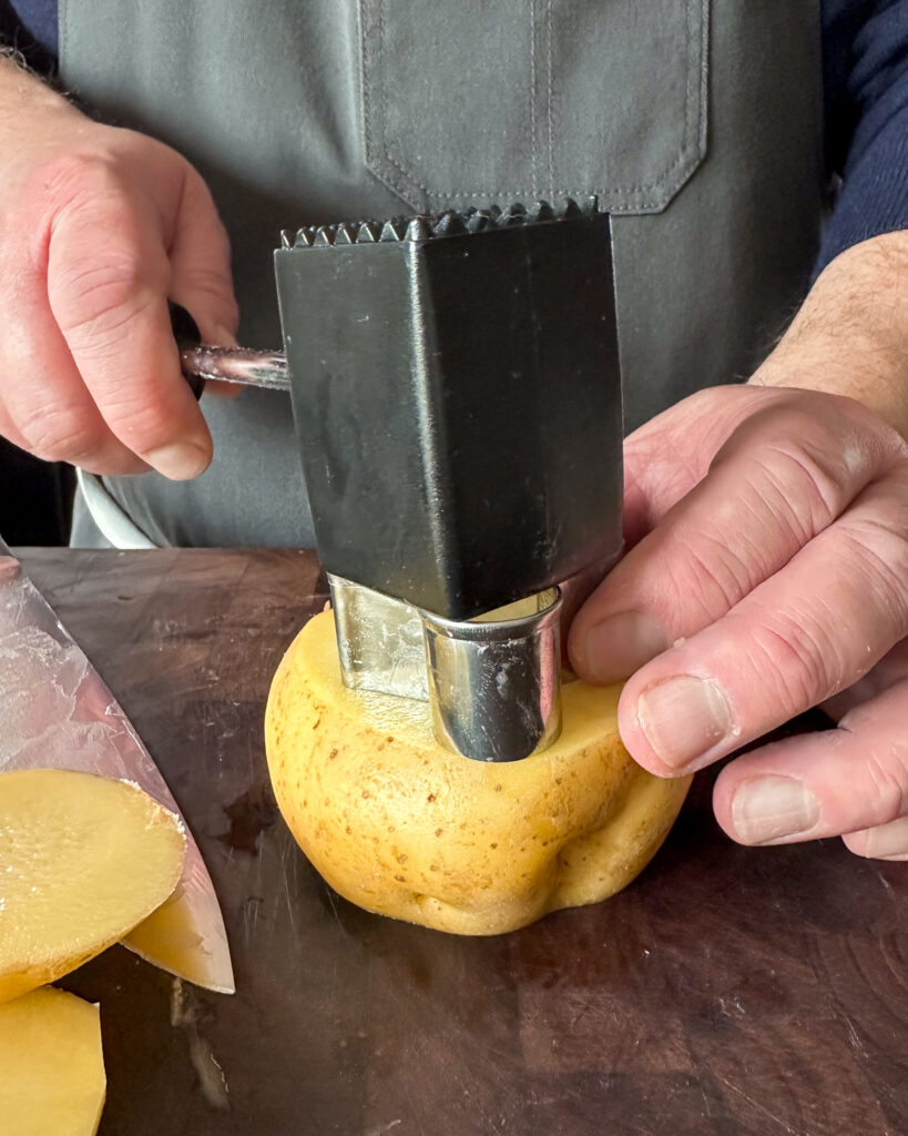 Place the cutter on top of the potatoes and using a kitchen mallet (or bottom of a can), bang the cutter deep into the potato.