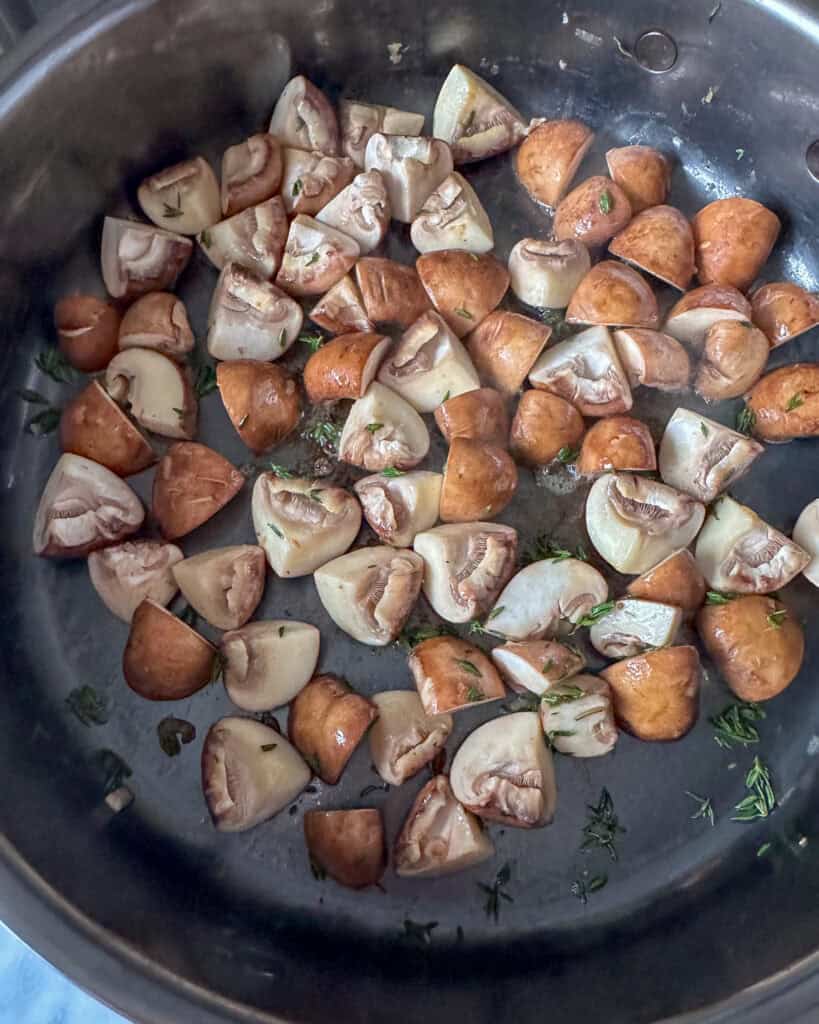 Sauté mushrooms in a pan.