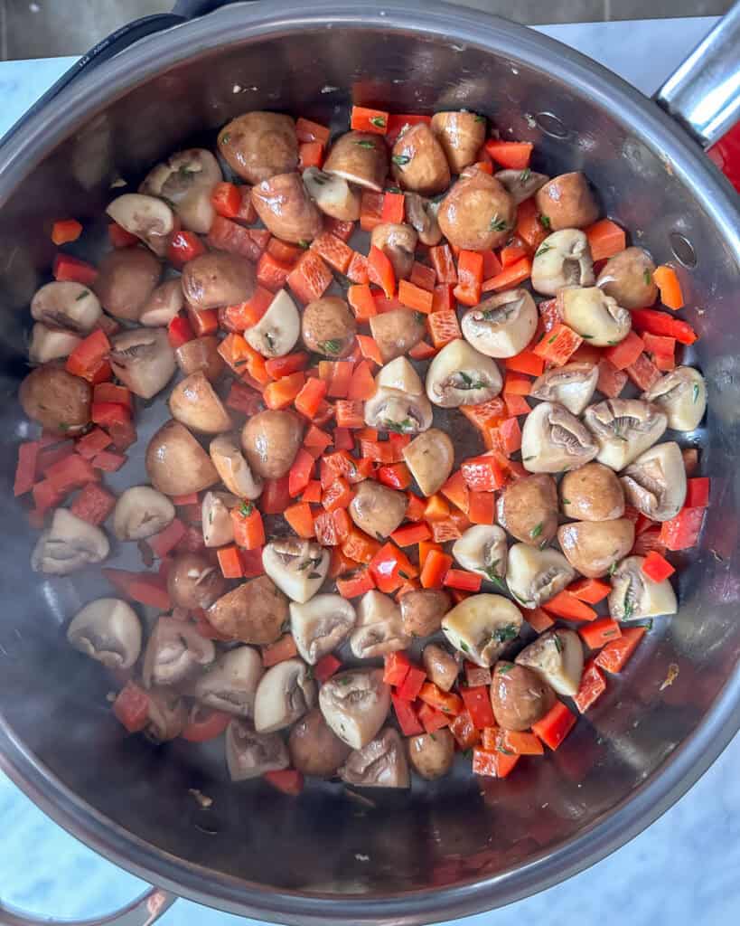 Add the red peppers to mushrooms and cook until softened.