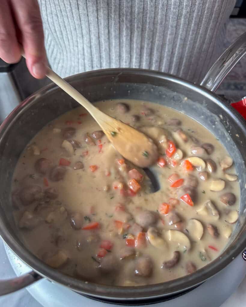 Add the stock ¼ cup at a time, stirring constantly to avoid a lumpy sauce.