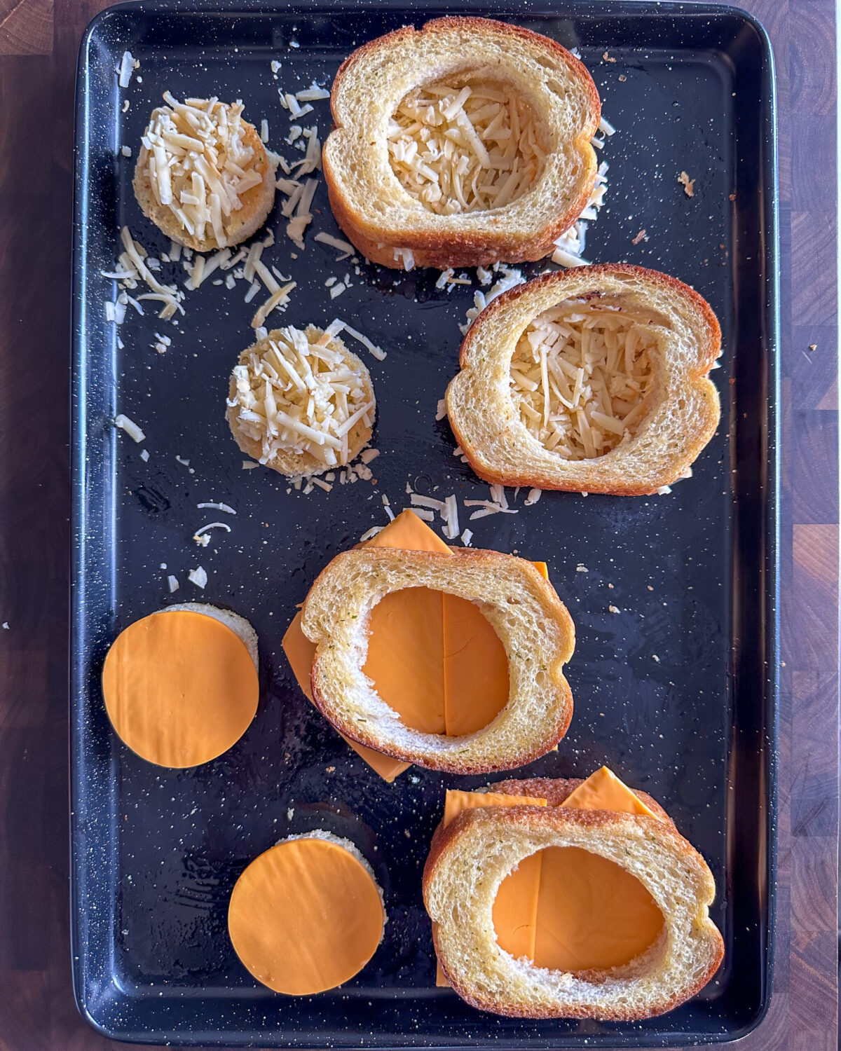 Add the processed cheese slices or grated smoked Gouda to the full toast slices. Place a toast slice with a circle cut out, on top of each cheese covered toast slice to form a sandwich.