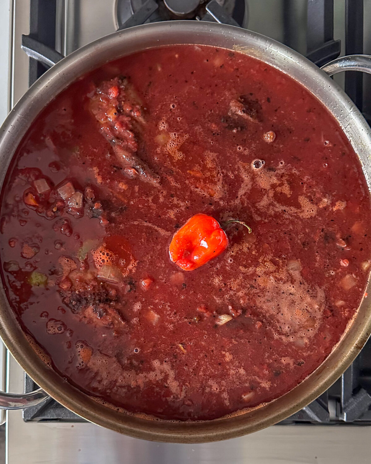Place the browned lamb shanks into the sauce, so they are mostly submerged.