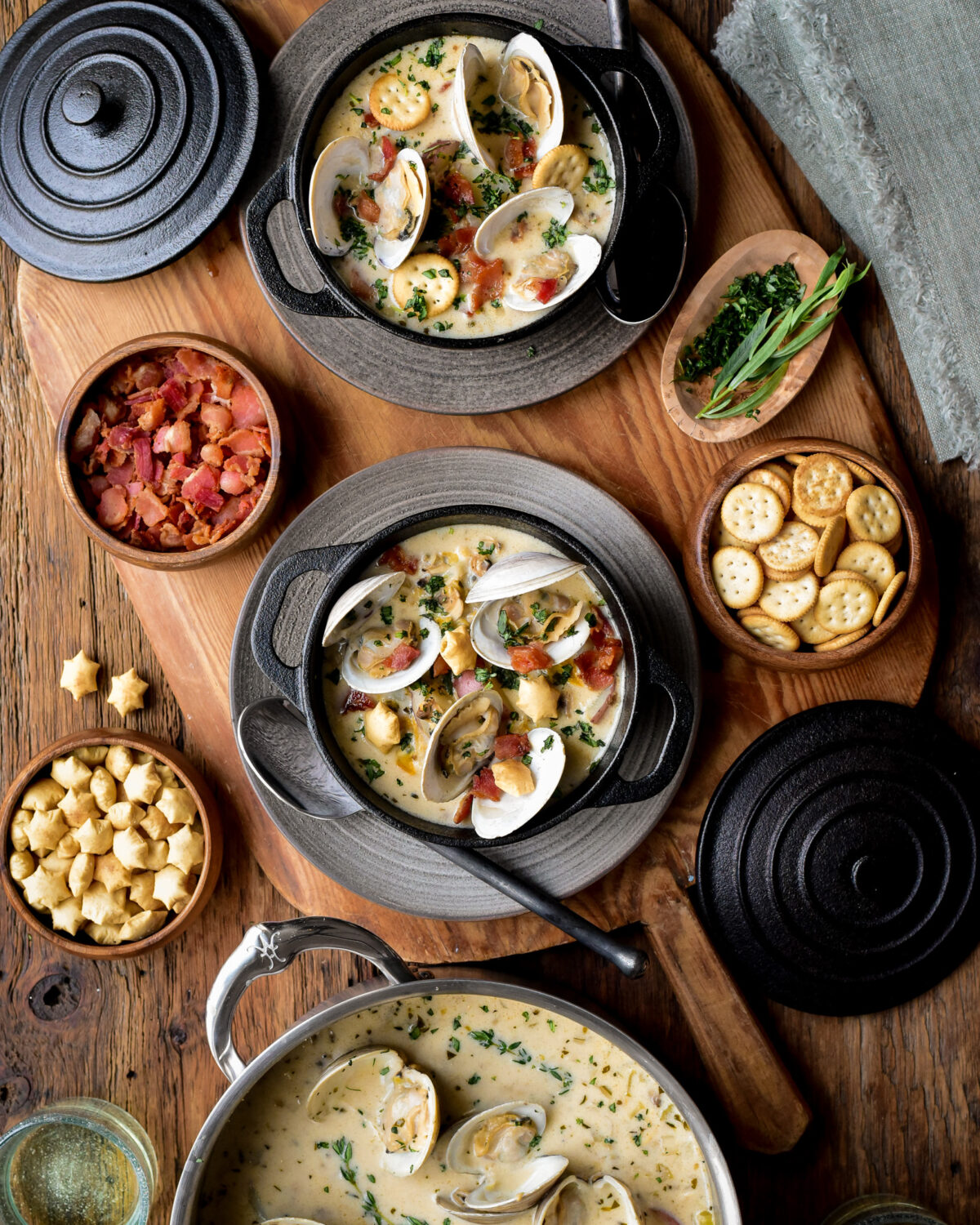 Fill individual serving bowls of clam chowder and top with chopped tarragon, diced bacon, steamed clams and crackers.