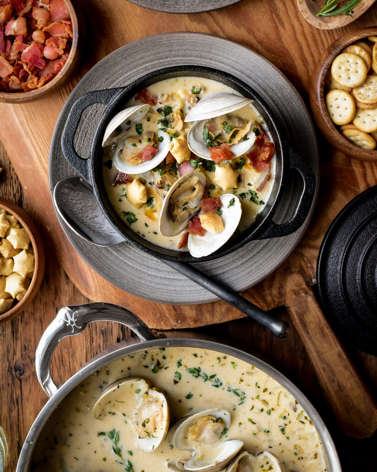 A bowl of and pot of Easy New England Clam Chowder.