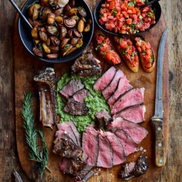 Florentine-Style Steak served with salsa verde, crispy potatoes (cooked in the beef fat trimmings) and bruschetta.