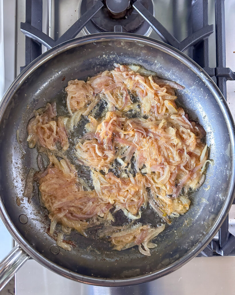 A skillet with slowly simmered caramelized onions.