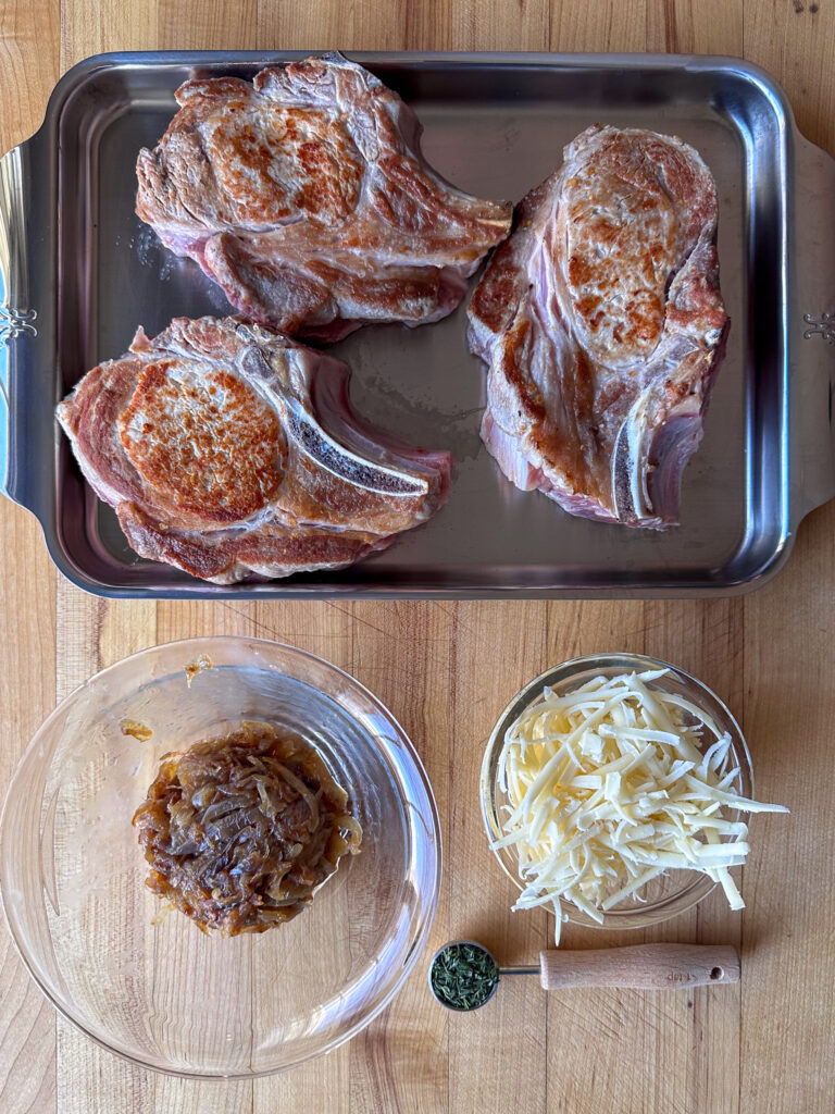 Seared chops ready to get stuffed with onions and cheese.