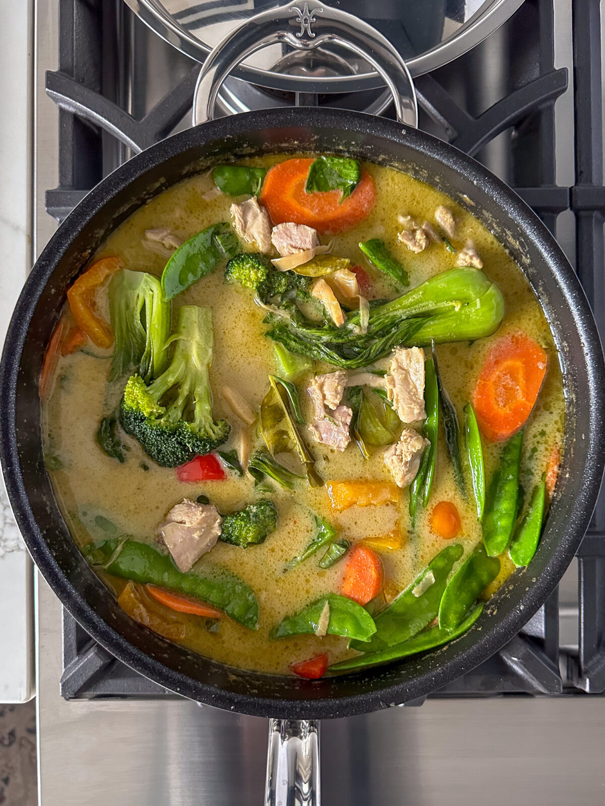 A simmering pot of Thai Green Curry Chicken & Vegetables 