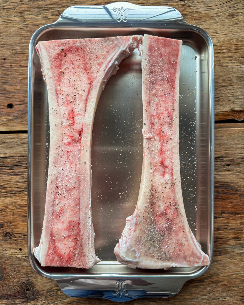2 - 11" beef center-cut bone marrow bones - canoe cut with salt and pepper.