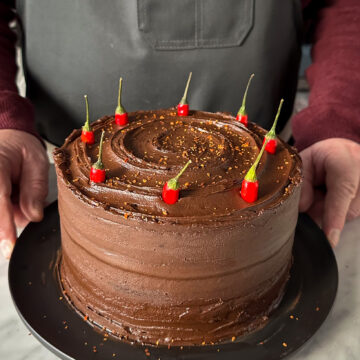 A spicy chocolate cake sprinkled with Korean chili flakes and decorated with Bird's Eye chilies.