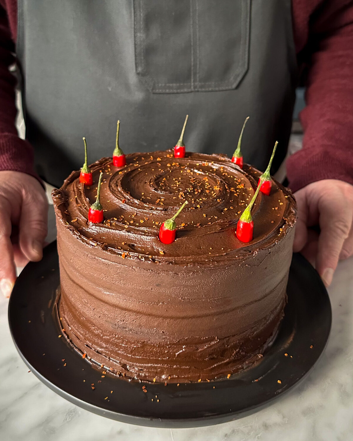 Sprinkle with Korean chili flakes and spear Bird's Eye chilies (optional) into the cake for garnish.