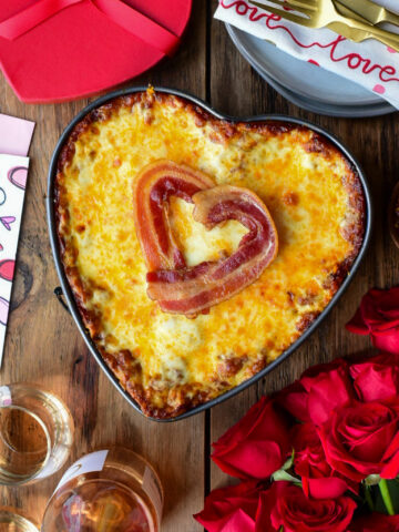 A heart shaped Lasagna with Bacon and Sausage in the filling and a bacon heart on the top.