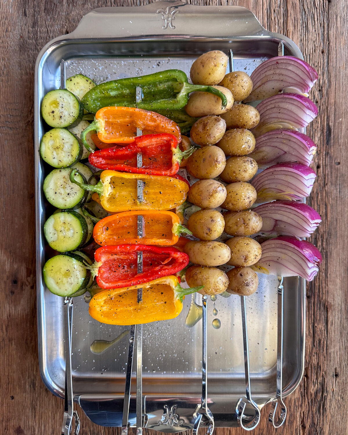 Thread each vegetable onto separate skewers and drizzle with olive oil and season with salt and pepper.