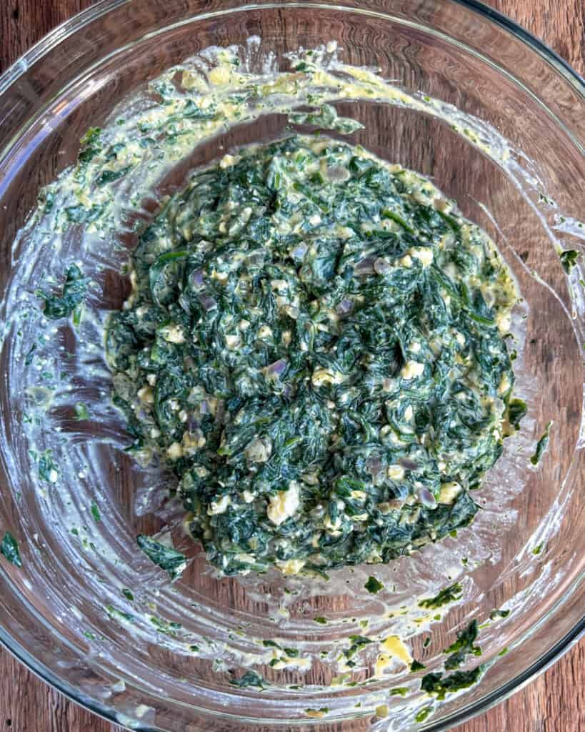 Ricotta and feta mixture mixed in with the spinach mixture.