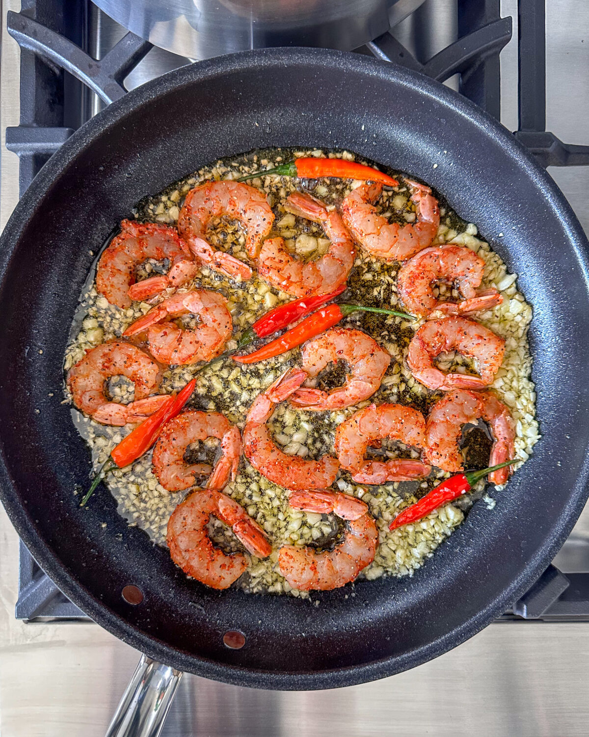 Add the seasoned shrimp into the skillet.