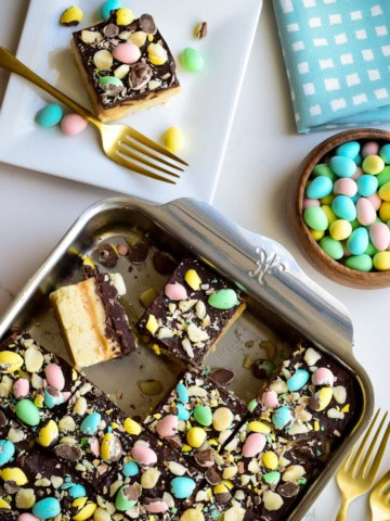 A baking pan with Mini Egg Millionaire’s Shortbread sliced up and served for Easter dessert.