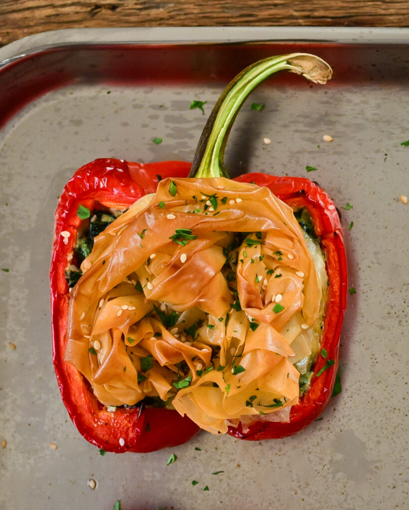 A close up of Spanakopita Stuffed Peppers with a crunchy phyllo topping.