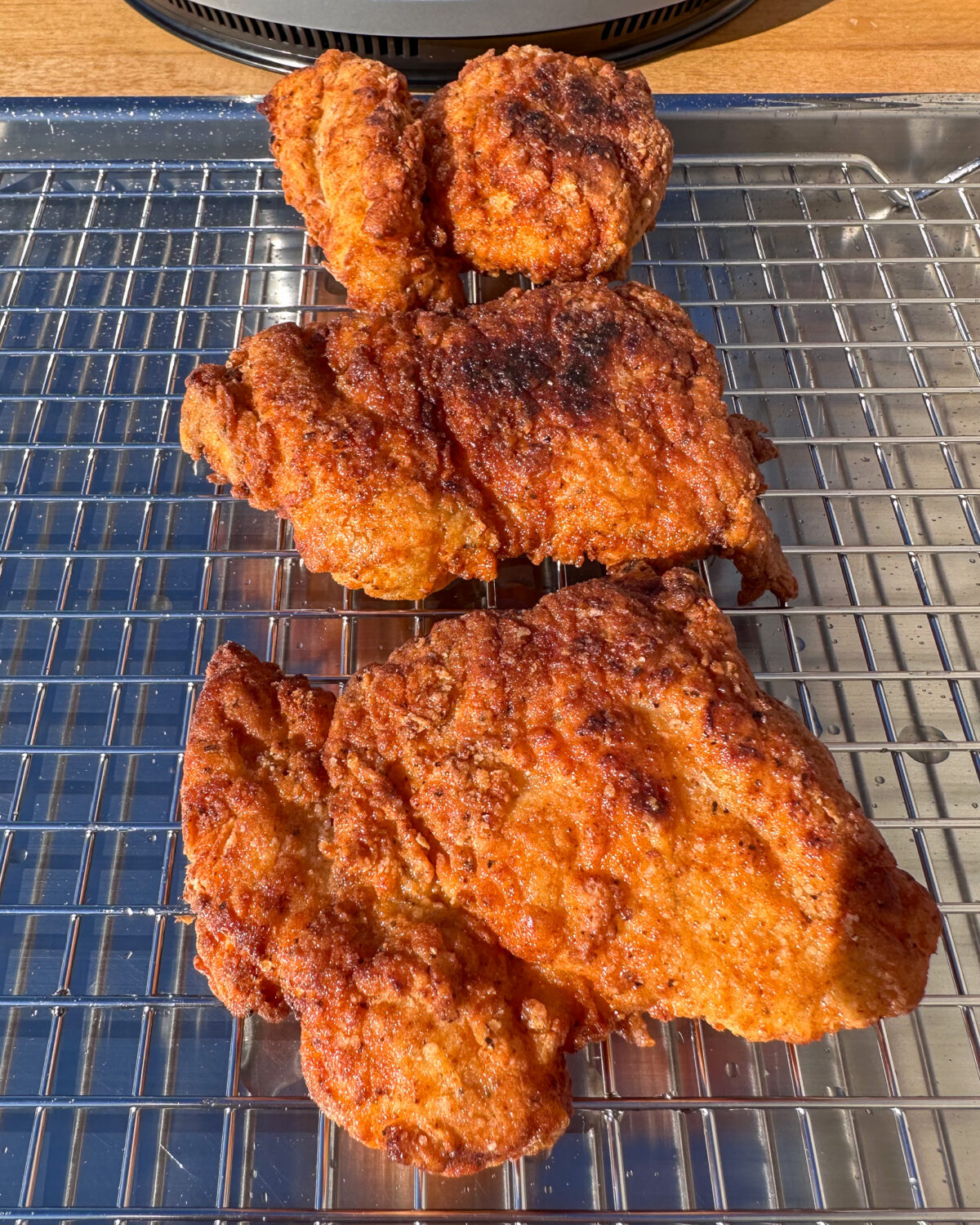 Place fried chicken on rack to drain.