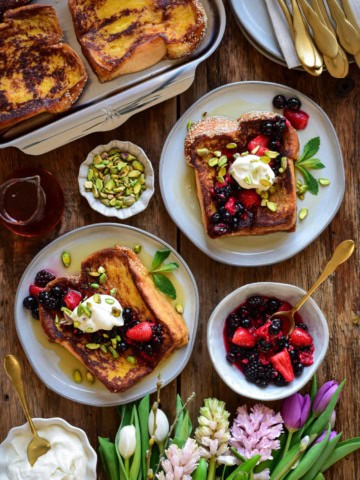 Two plates of Challah French Toast with Mascarpone and Berries.
