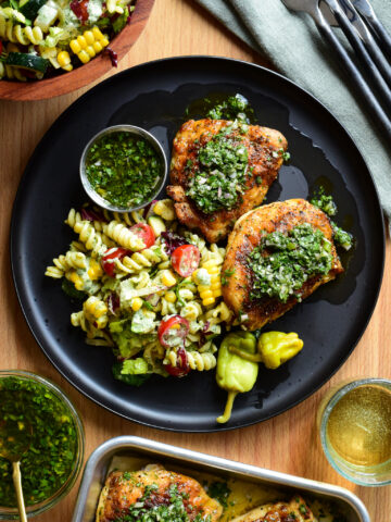 Two Chicken Thighs made in the air fryer and served chimichurri and a BLT pasta salad.