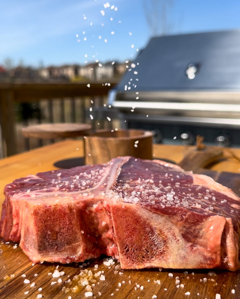 Season the T-bone steak with kosher salt.