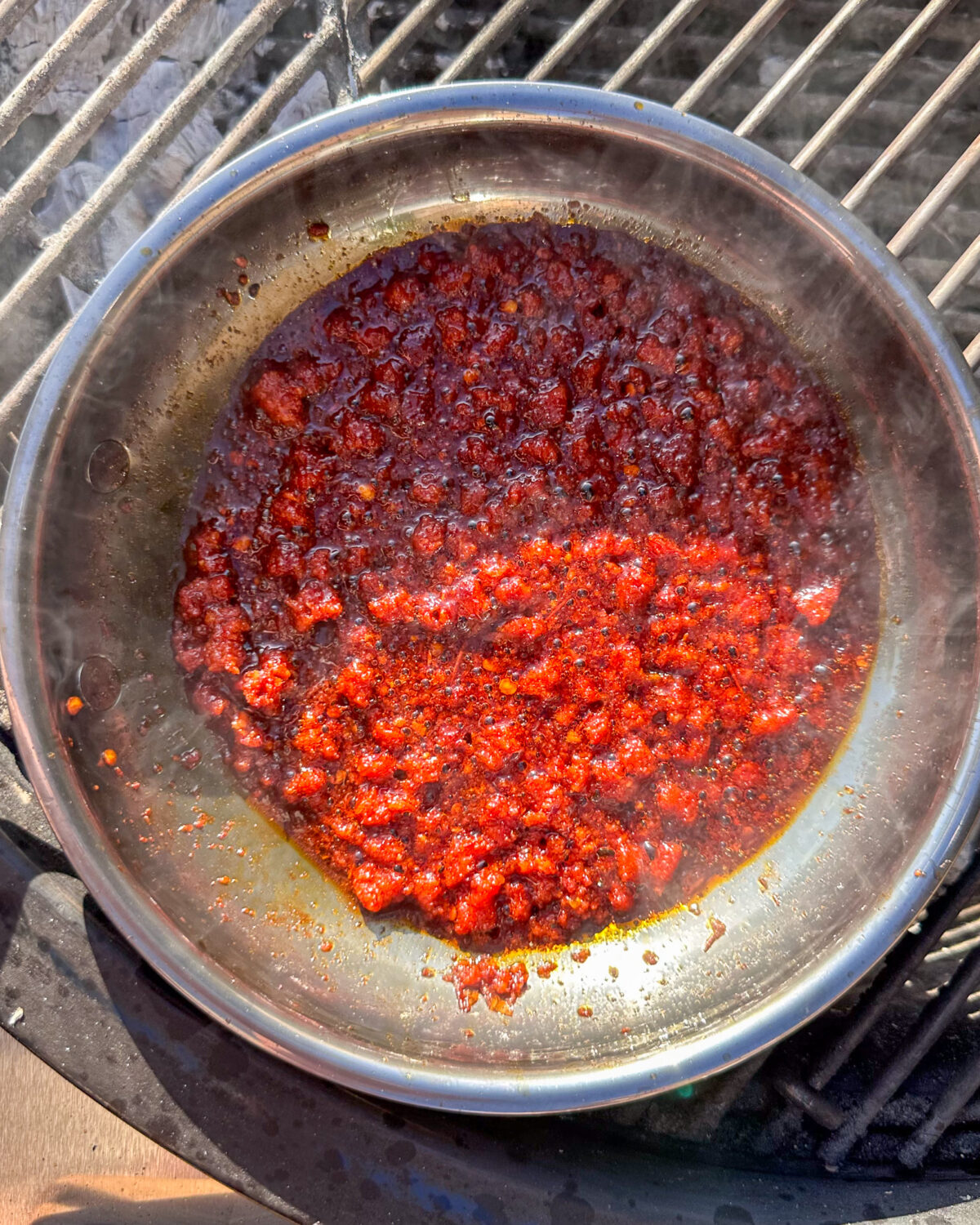 Place the 'Nduja crumbles in a small skillet over the direct heat. Cook until it starts to melt and release its oils