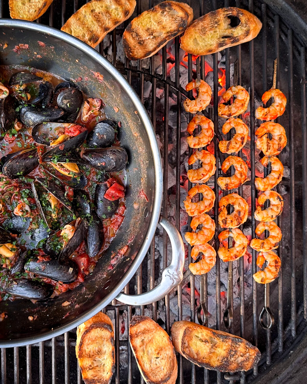 Sear the shrimp skewers over the hot coals for 2 minutes per side then add them to the wok.