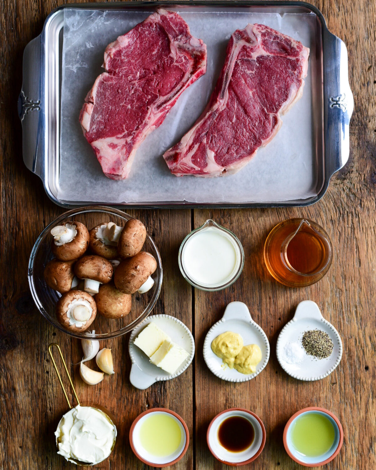 Ingredients laid out for a grilled steaks with mushroom sauce recipe.