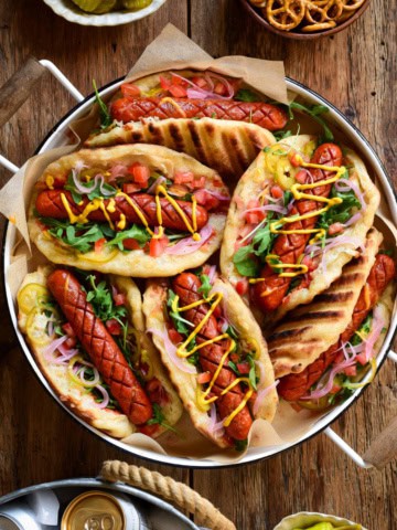 A tray filled with colourful Grilled Smokie Pizza Sandwiches.