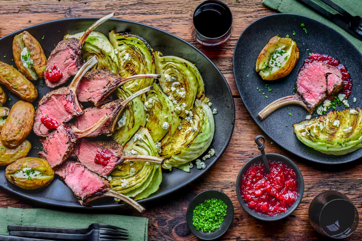 Grilled venison rib rack served with grilled cabbage, baked potatoes and a cranberry-apple sauce.