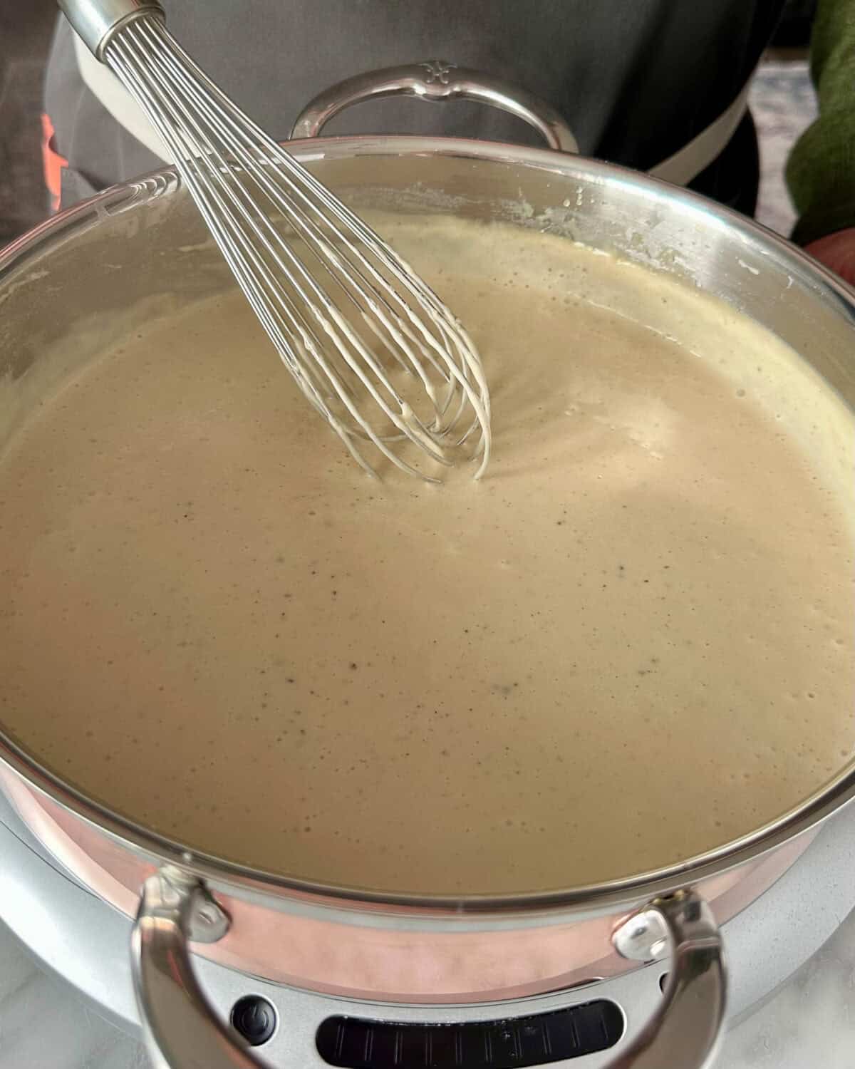 Slowly whisk in milk, cream, and Guinness. Stir until thickened. Add mustard, nutmeg, salt, and pepper.