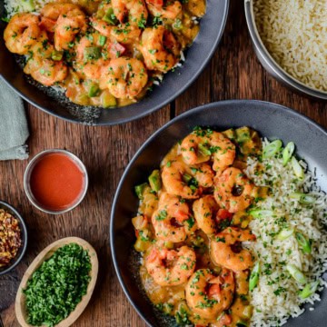 Two bowls of Shrimp Étouffée served with rice.