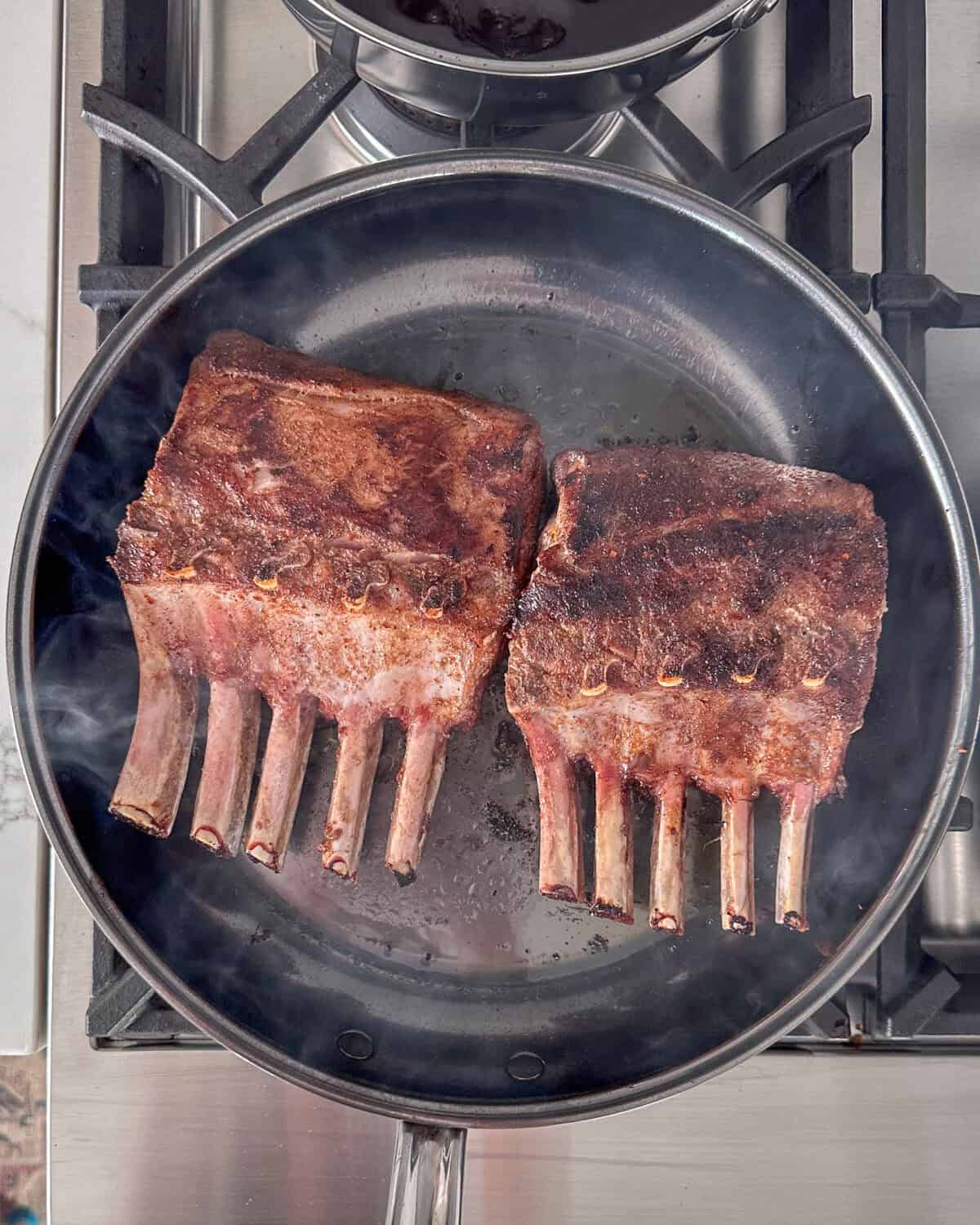 Sear the rib racks for 2–3 minutes per side until nicely browned.