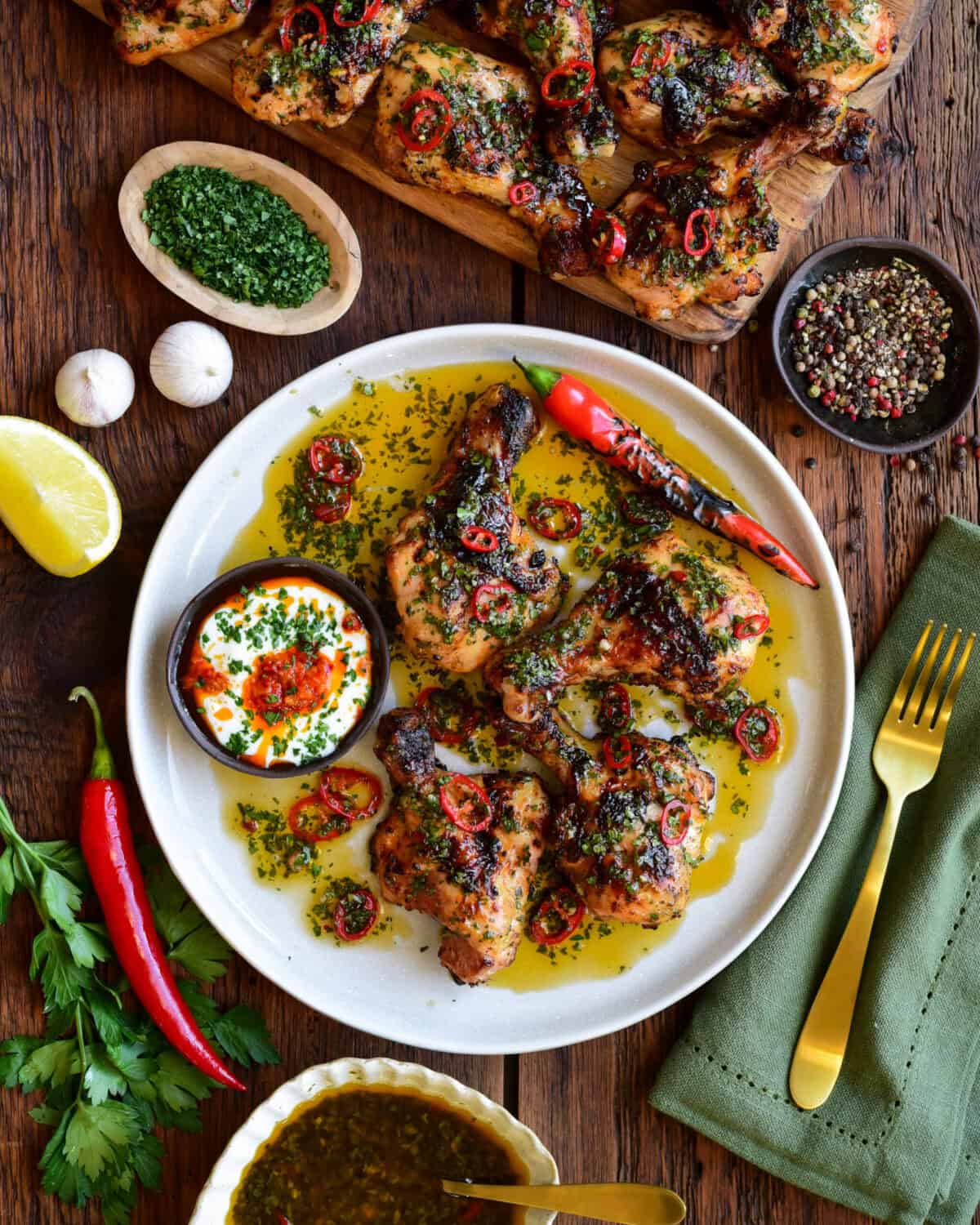 A plate of Butterflied Chicken Drumsticks with Sweet & Spicy Herb Sauce.