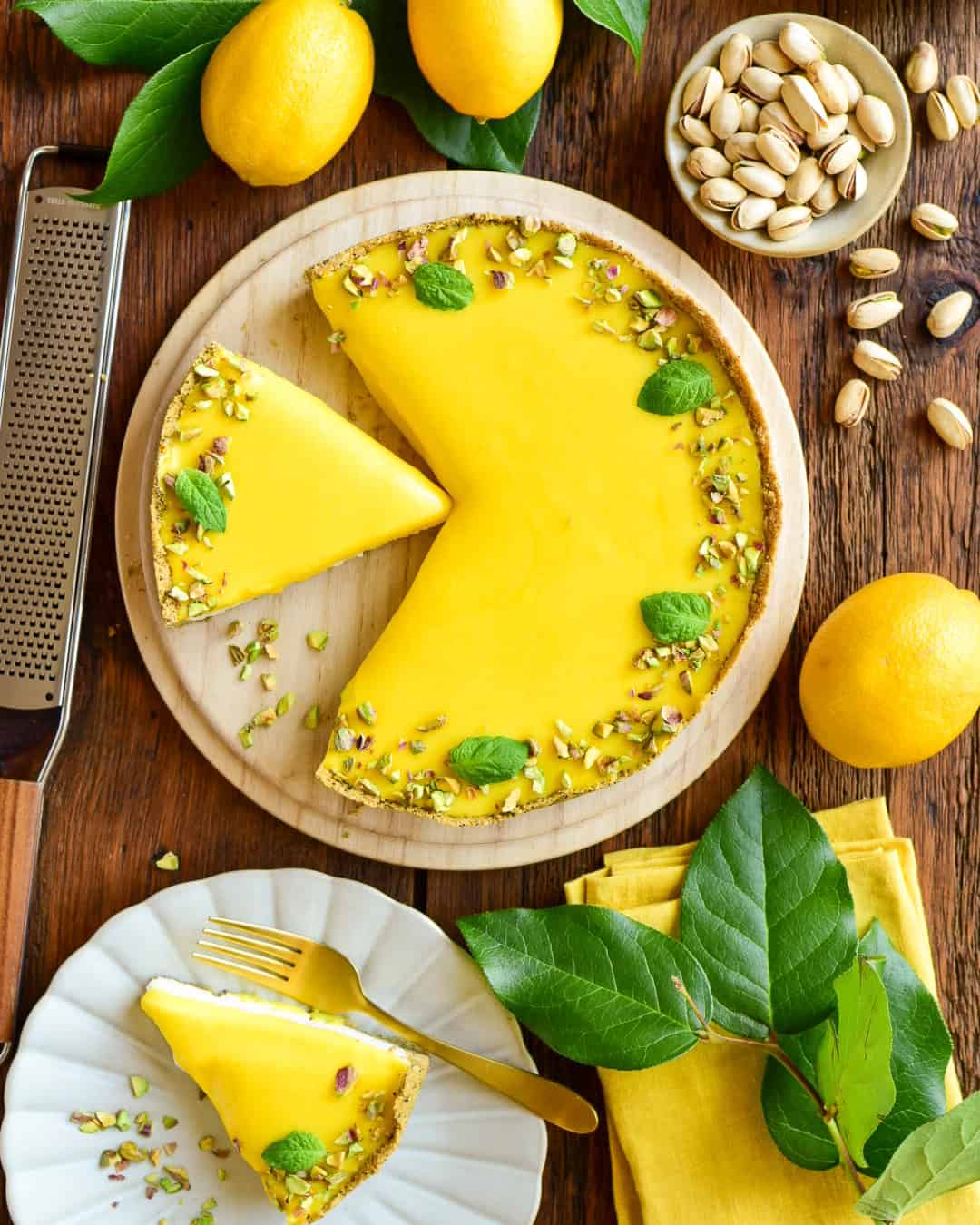 A no bake lemon curd pie with a few pieces cut out.