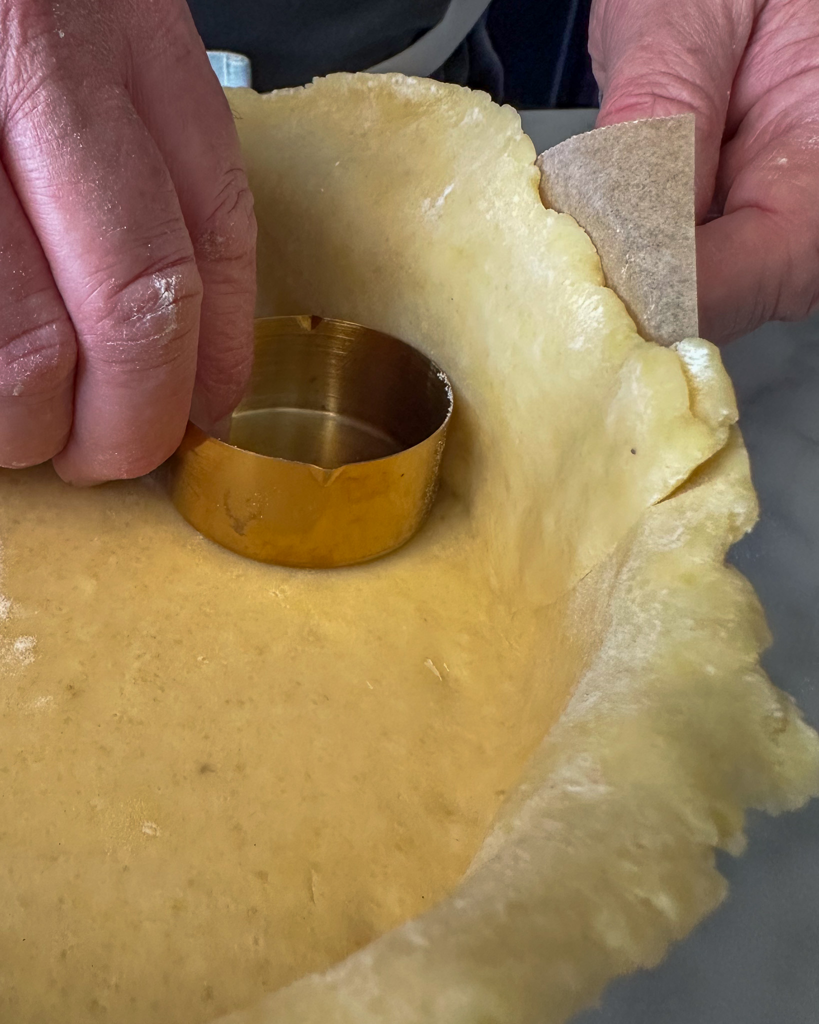 Use a ½-cup measuring cup to gently press the quiche dough into the corners where the bottom meets the sides.