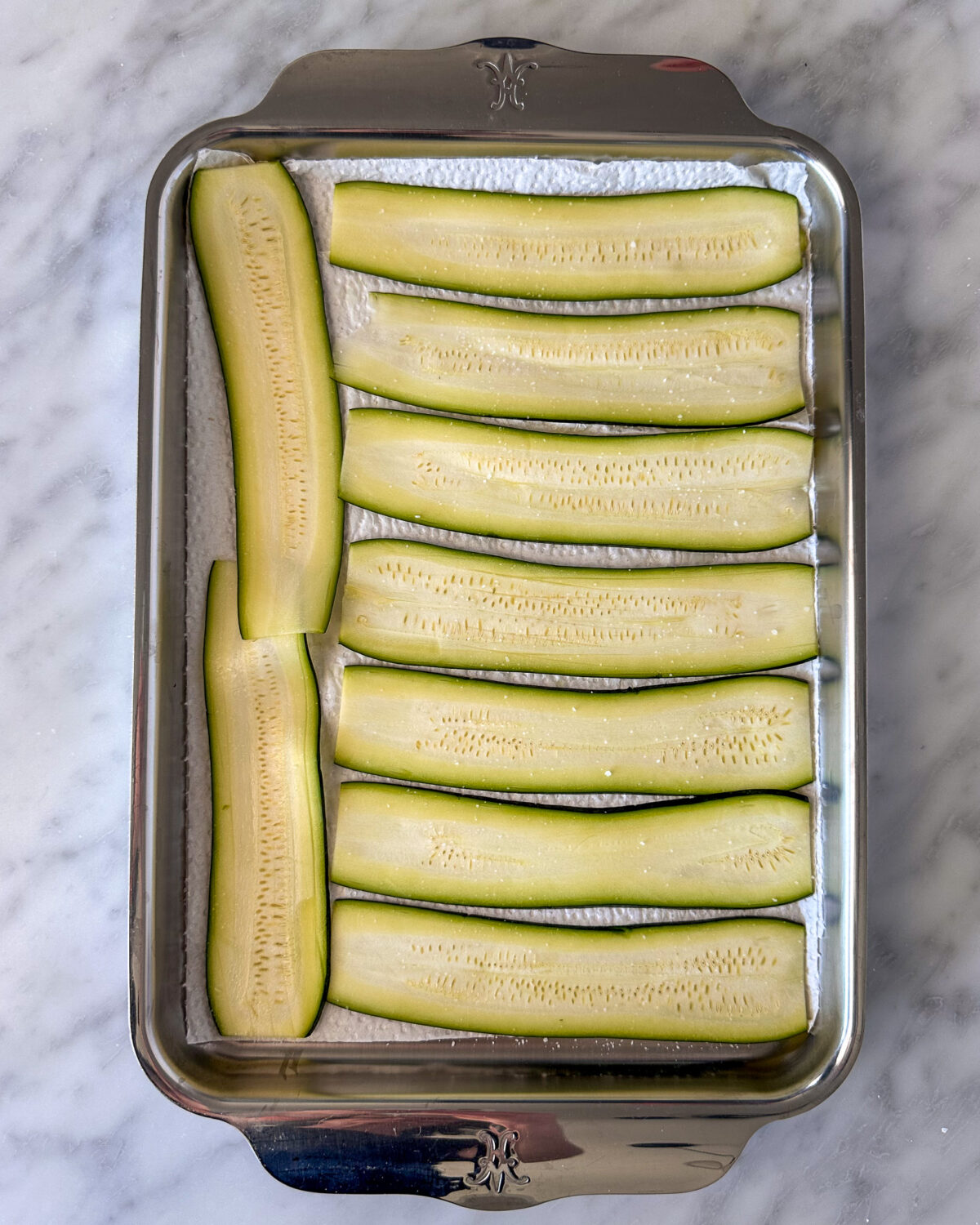 Lightly salt zucchini strips and let sit for 10–15 minutes on paper towels
