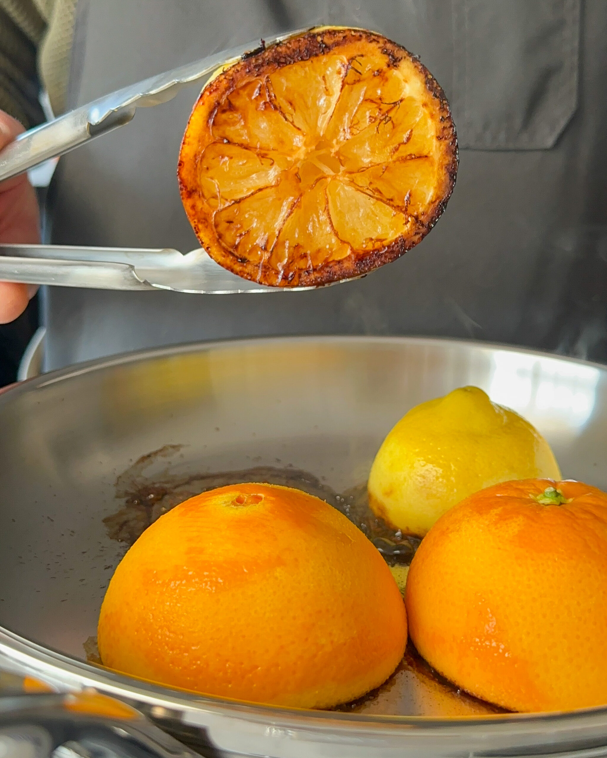 Cut the citrus in half and place the cut side down in the hot pan. Press gently and let cook undisturbed for 3–5 minutes until charred.