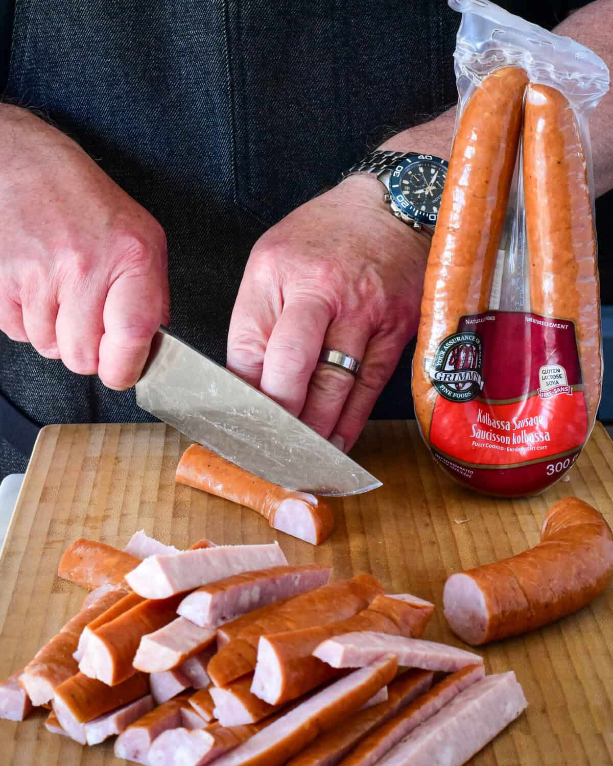 Cutting the kielbasa into strips for air frying.