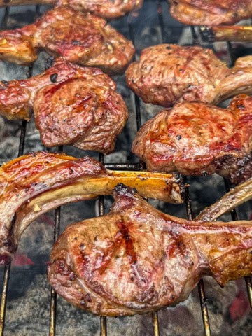 Grilled lamb lollipops over charcoal.