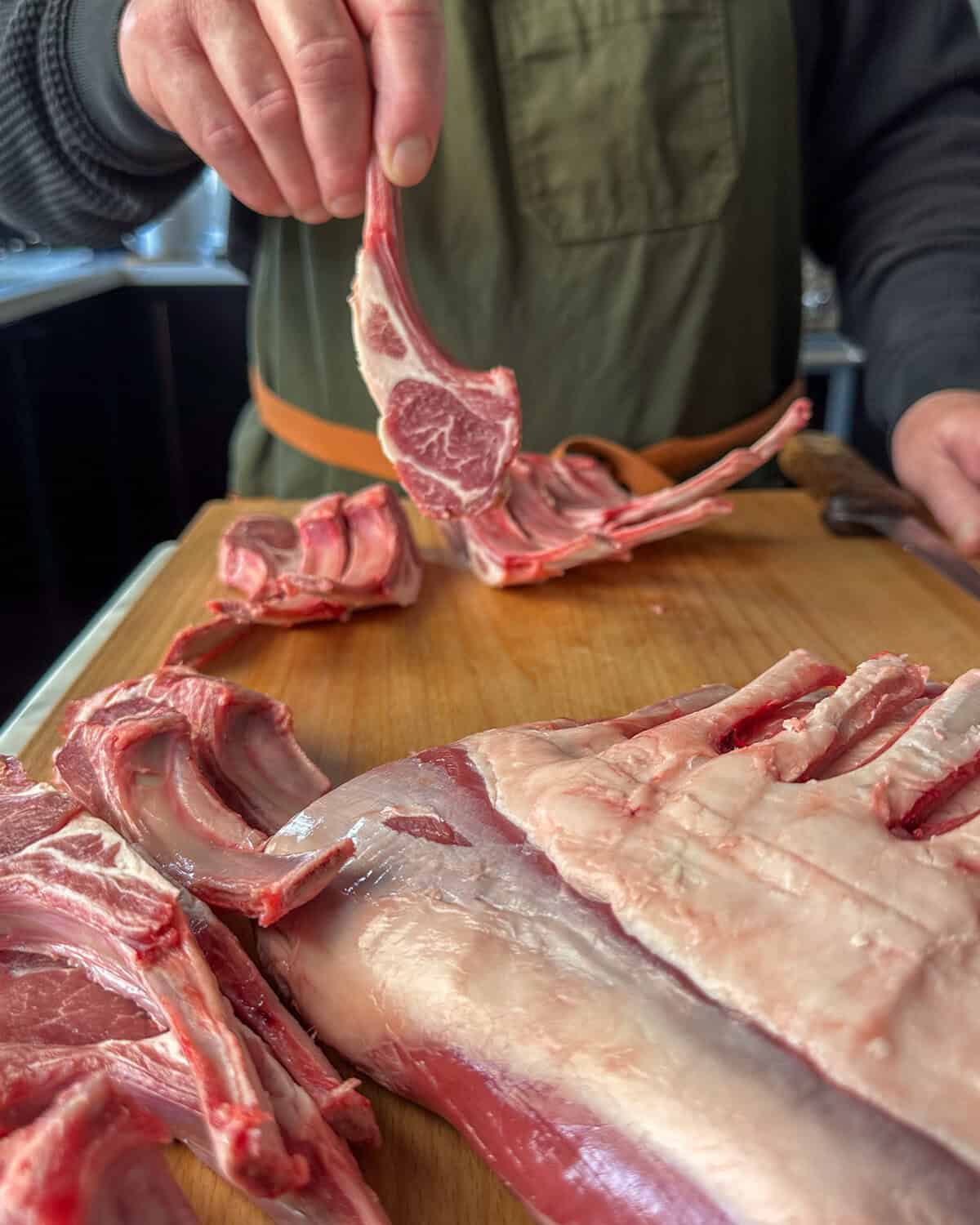 Using a sharp knife, carefully cut each rack of lamb between each bone to create individual lollipop lamb chops.