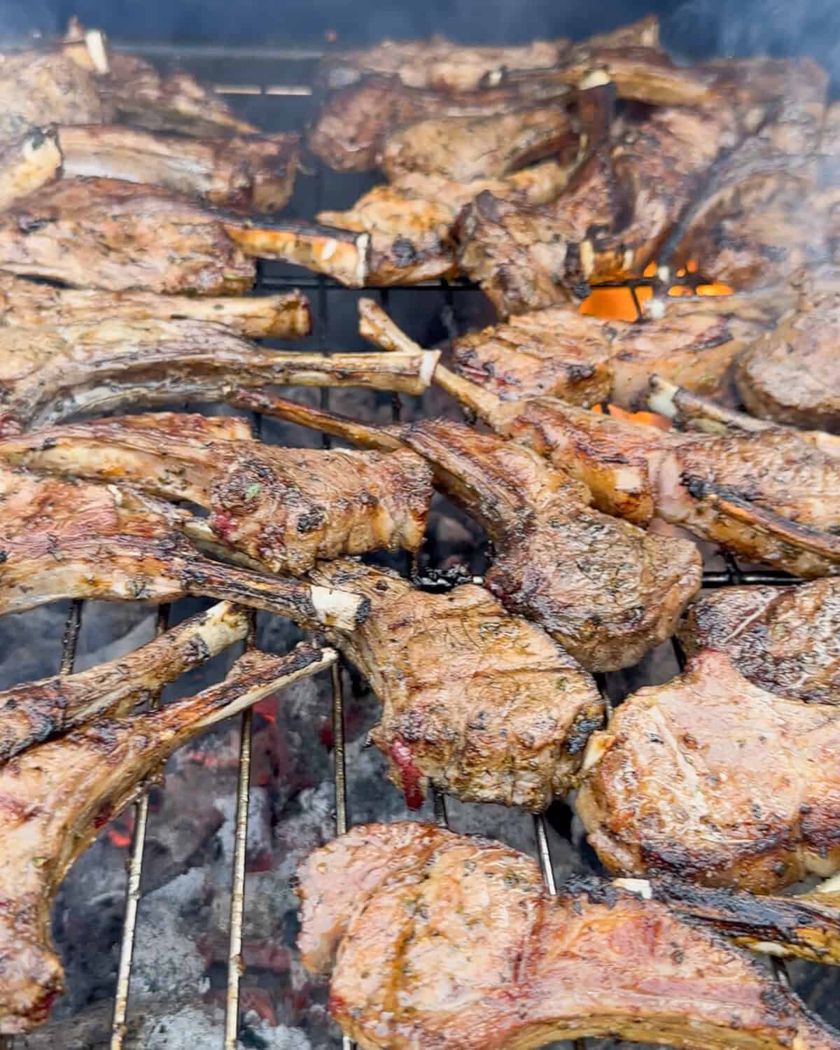 A BBQ filled with cooked lamb chops.