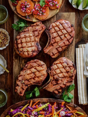 Four reverse seared pork chops served with an orange salsa and a smoky mojo red cabbage slaw.