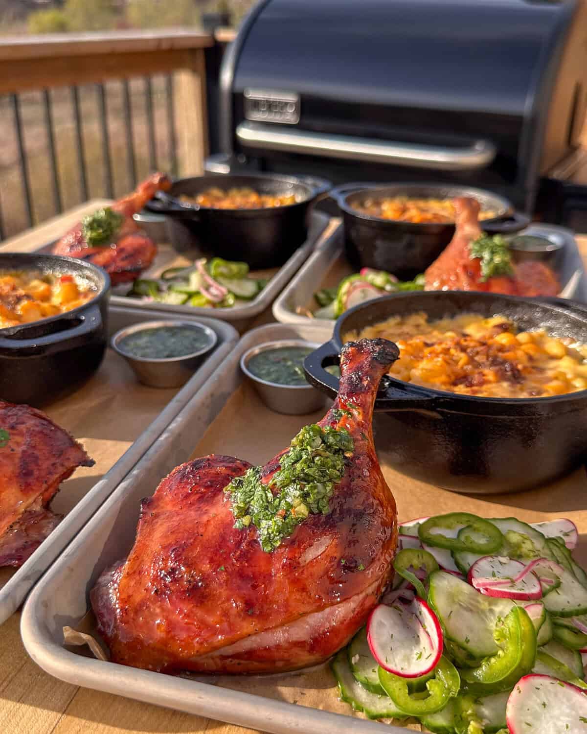 Plated duck legs served with mac & cheese and a cucumber salad.